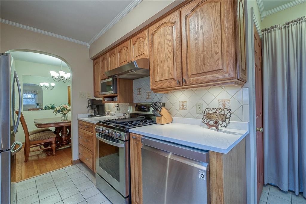 2618 New England Road West Mifflin, PA 15122 - Photo 7 of 25 a kitchen with stainless steel appliances granite countertop a stove a sink and a microwave