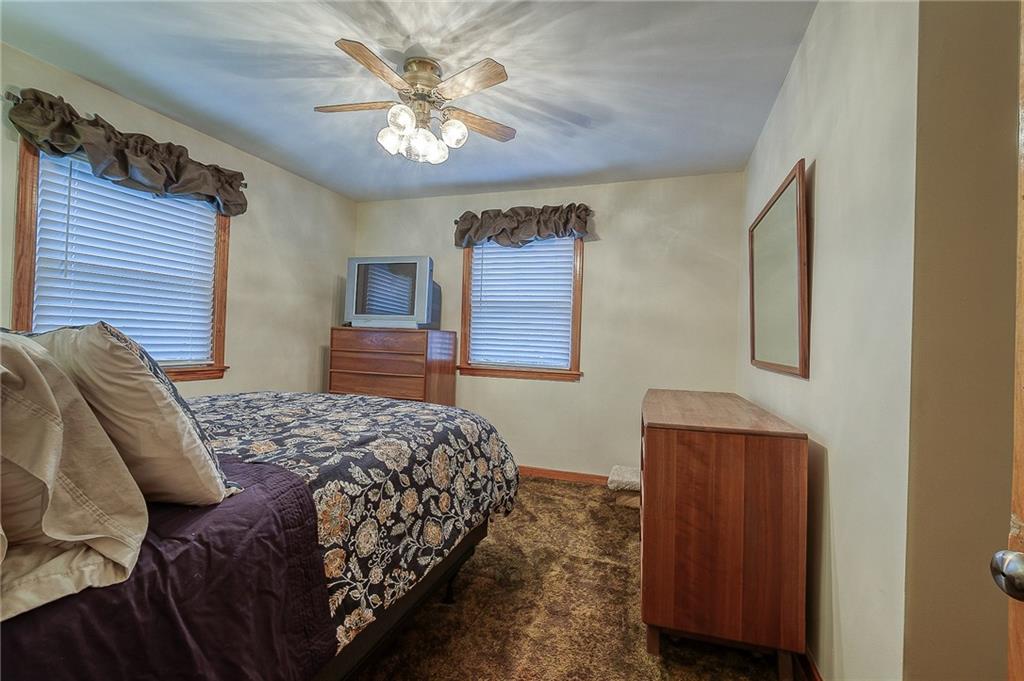 2618 New England Road West Mifflin, PA 15122 - Photo 9 of 25 a bedroom with a bed and a chandelier