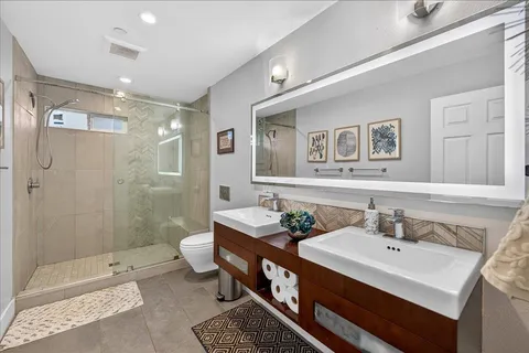 a bathroom with a sink double vanity and a shower