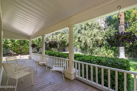 a view of a chairs and table in the balcony