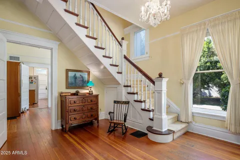 a view of entryway with wooden floor and front door