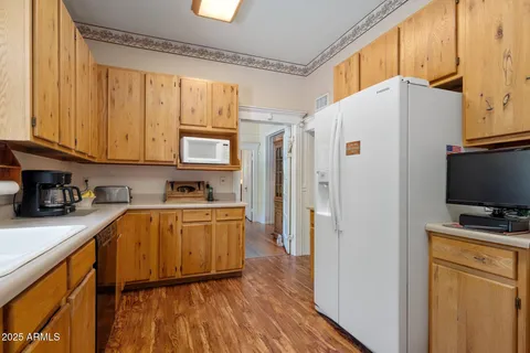 a kitchen with stainless steel appliances a refrigerator sink and cabinets