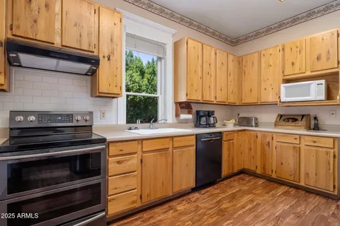 a kitchen with stainless steel appliances granite countertop a stove and cabinets