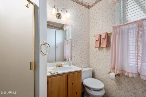 a spacious bedroom with a bed a desk and chair