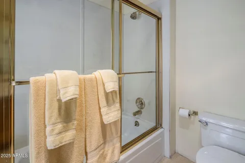 a bedroom with a bed and a table