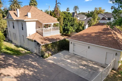 an aerial view of a house with garden space and street view