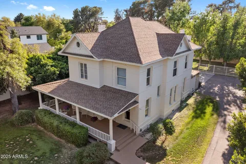 an aerial view of a house with swimming pool and garden space