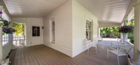 a view of an entryway with wooden floor and garden