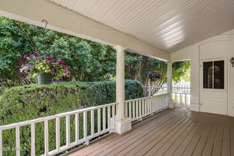 a view of a porch with wooden floor and yard