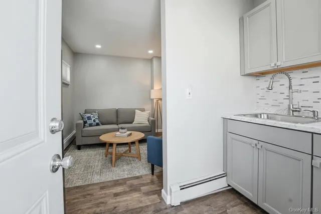 a living room with furniture and a painting on the wall