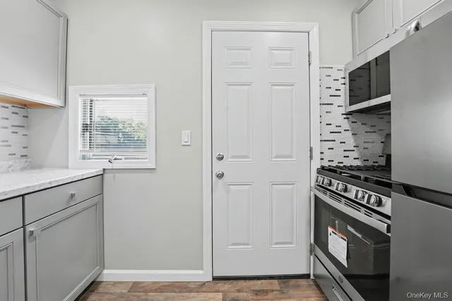 a view of an entryway with wooden floor