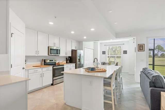 a kitchen with sink a stove and cabinets