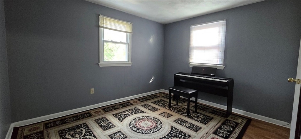 129 Madison Avenue, Unit 2 Arlington, MA 02474 - Photo 4 of 8 a room with chair and a window