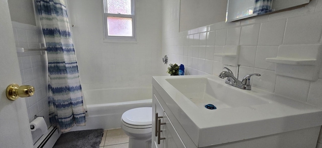 129 Madison Avenue, Unit 2 Arlington, MA 02474 - Photo 6 of 8 a bathroom with a sink toilet and shower