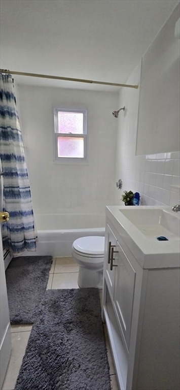 129 Madison Avenue, Unit 2 Arlington, MA 02474 - Photo 7 of 8 a bathroom with a sink a toilet and shower
