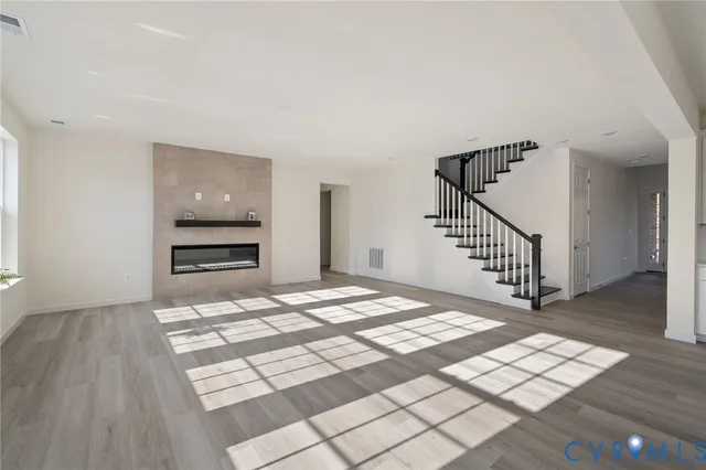 a view of a hallway with wooden floor and dining room
