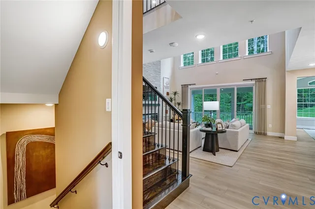 a view of a hallway with furniture and stairs