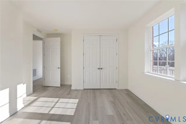 a view of wooden floor and windows in a room