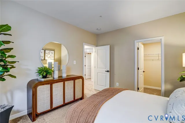 a bedroom with windows and wooden floor