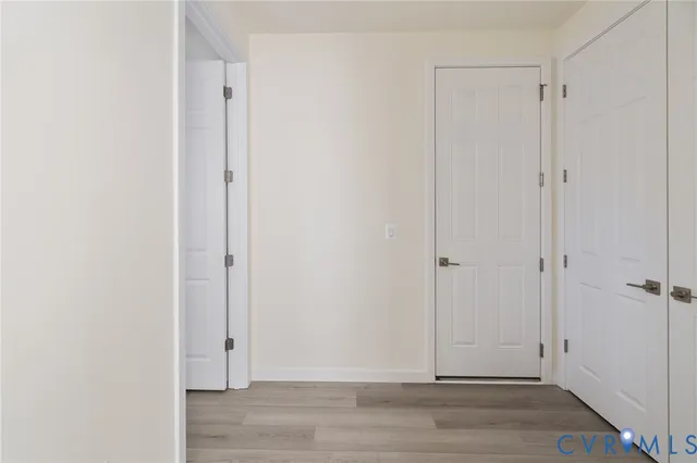 a view of room with wooden floor