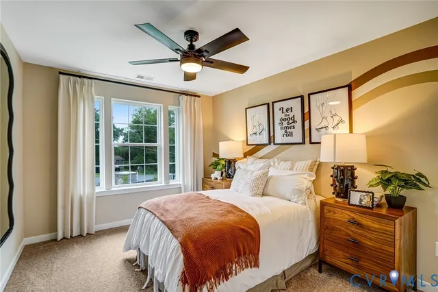 a bedroom with a large bed and a window