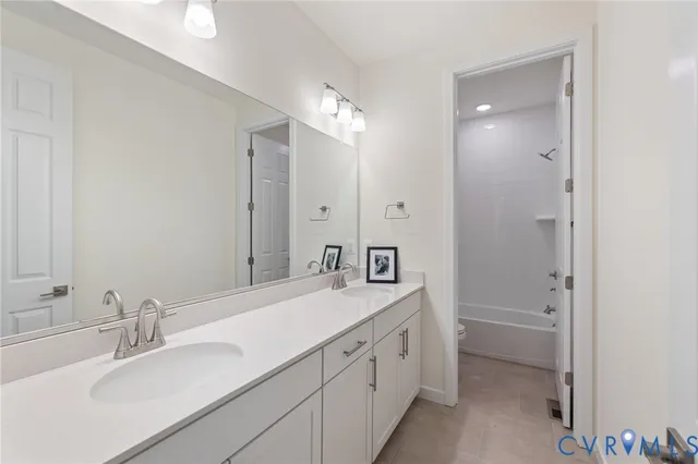 a view of an empty room with window and bathroom