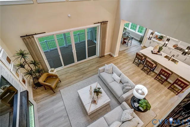 a living room with furniture and floor to ceiling windows