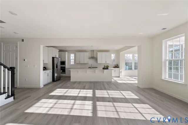 a view of a kitchen with refrigerator and windows