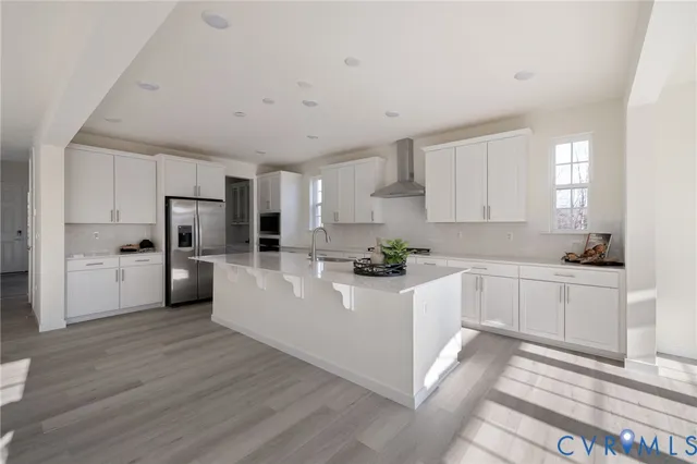 a kitchen with white cabinets and white appliances