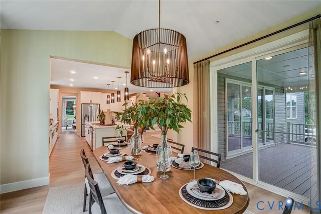 a dining room with furniture and wooden floor
