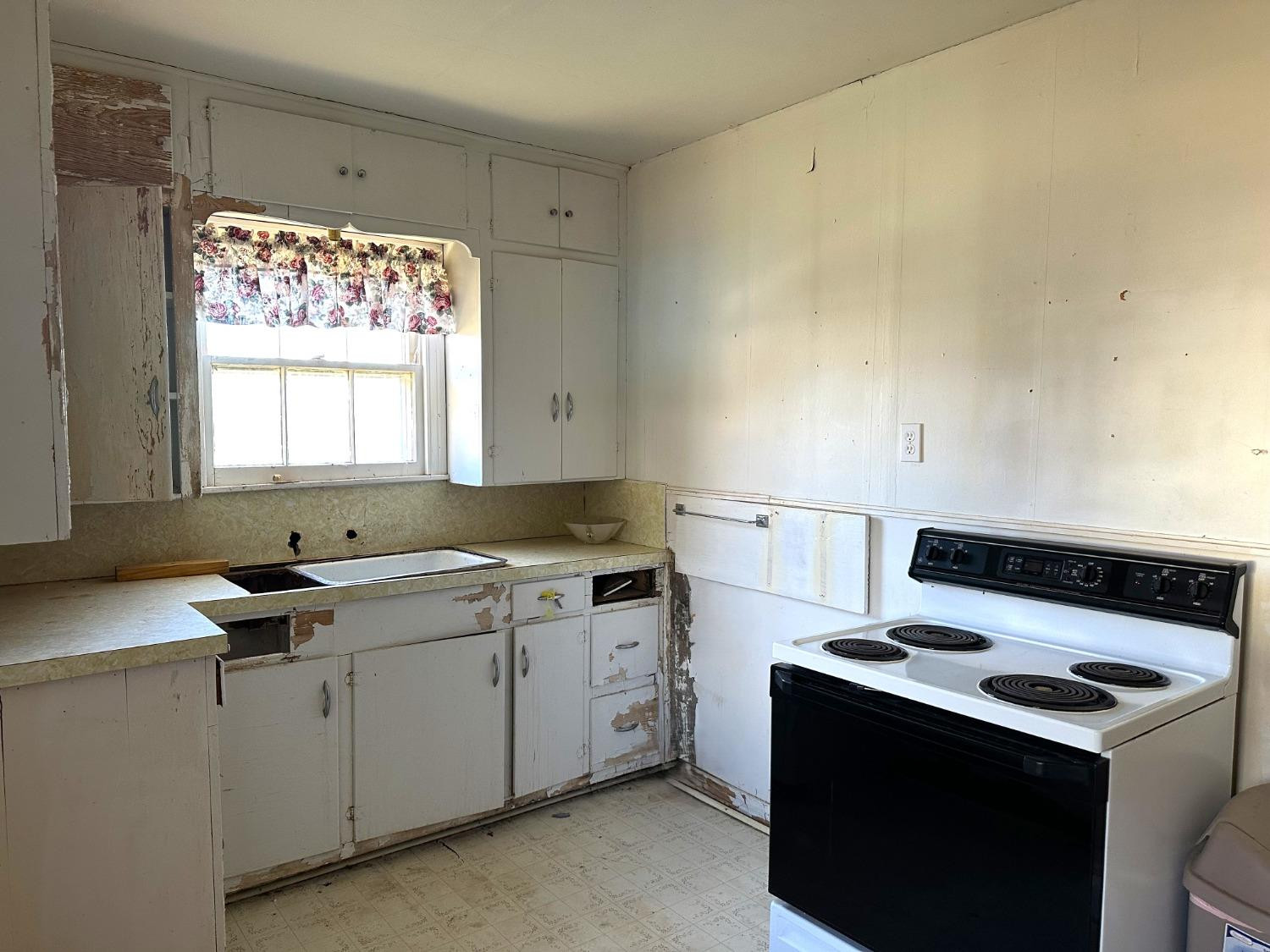 610 Trumbull Avenue Spur, TX 79370 - Photo 13 of 14 a kitchen with a stove and a sink