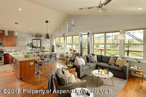 a living room with lots of furniture and a large window