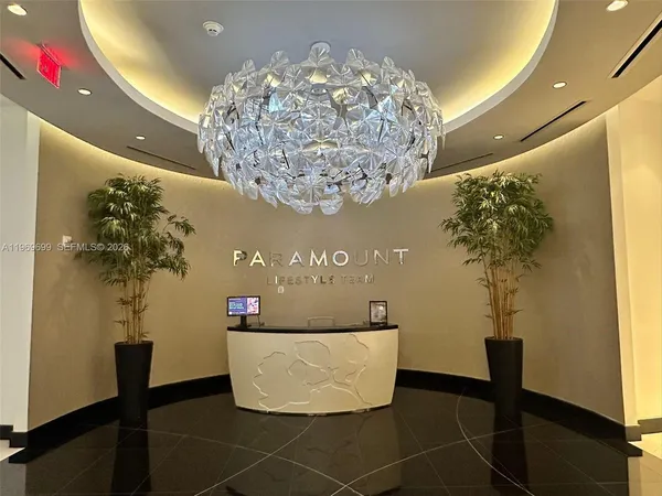 a living room with furniture a flat screen tv and a large window