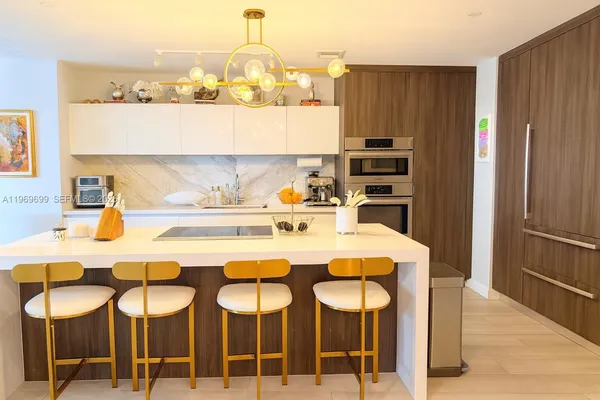 a kitchen with a dining table and chairs