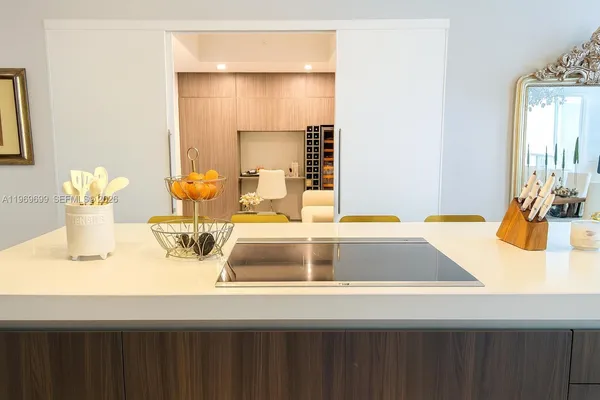 a kitchen with a sink and a large mirror