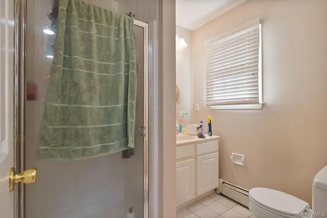 a bathroom with a sink toilet and window