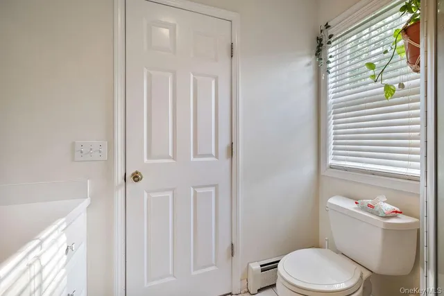 a white toilet sitting next to a bathroom sink