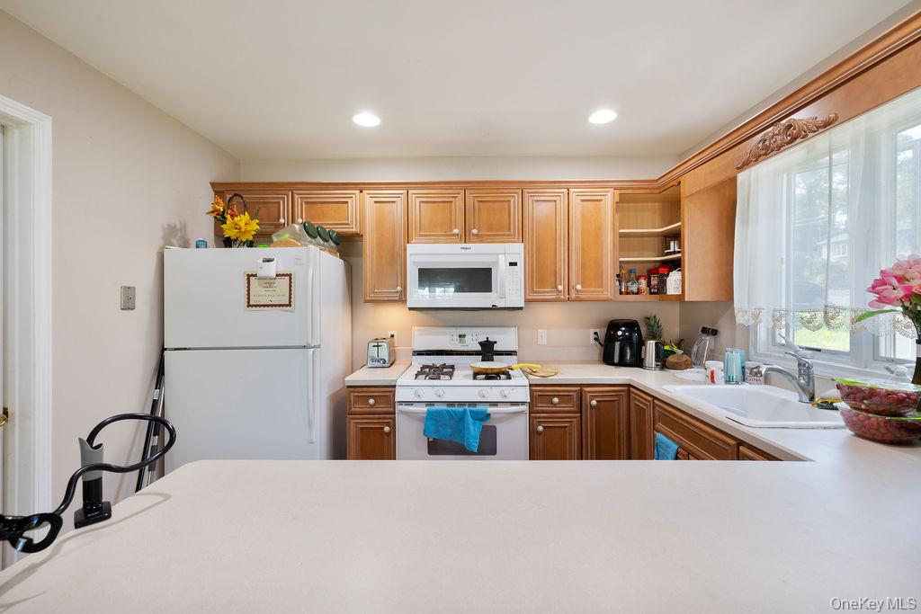 30 Chestnut Street Stony Point, NY 10980 - Photo 2 of 34 a kitchen with stainless steel appliances granite countertop a sink a stove a refrigerator with white cabinets and wooden floor