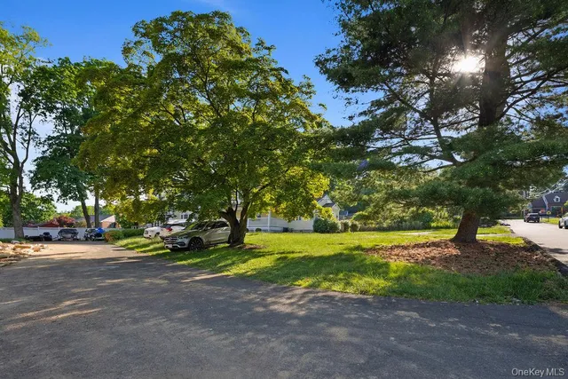 a view of a street with houses and trees
