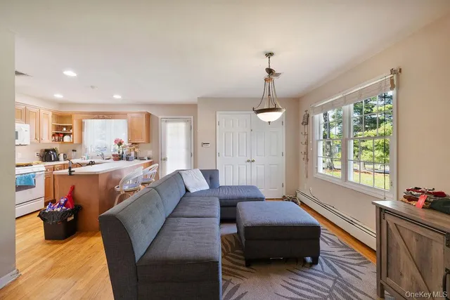 a living room with furniture and a chandelier