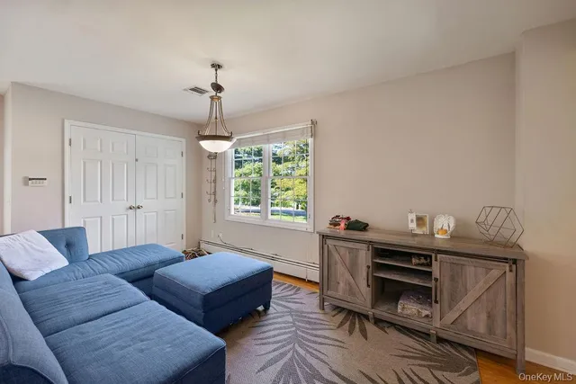 a living room with furniture a window and a chandelier