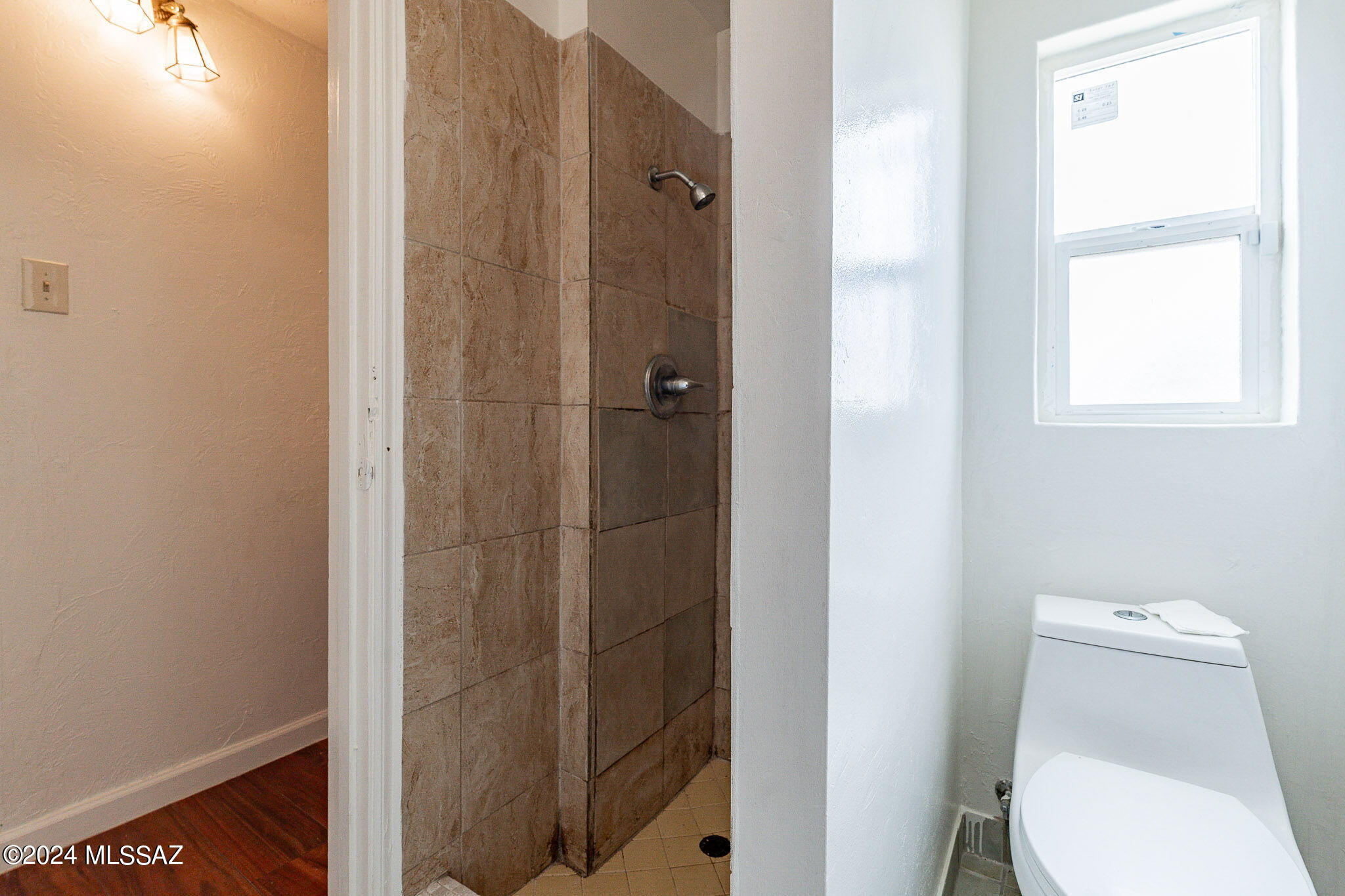608 East Roger Road Tucson, AZ 85705 - Photo 11 of 13 a white toilet sitting next to a bathroom sink