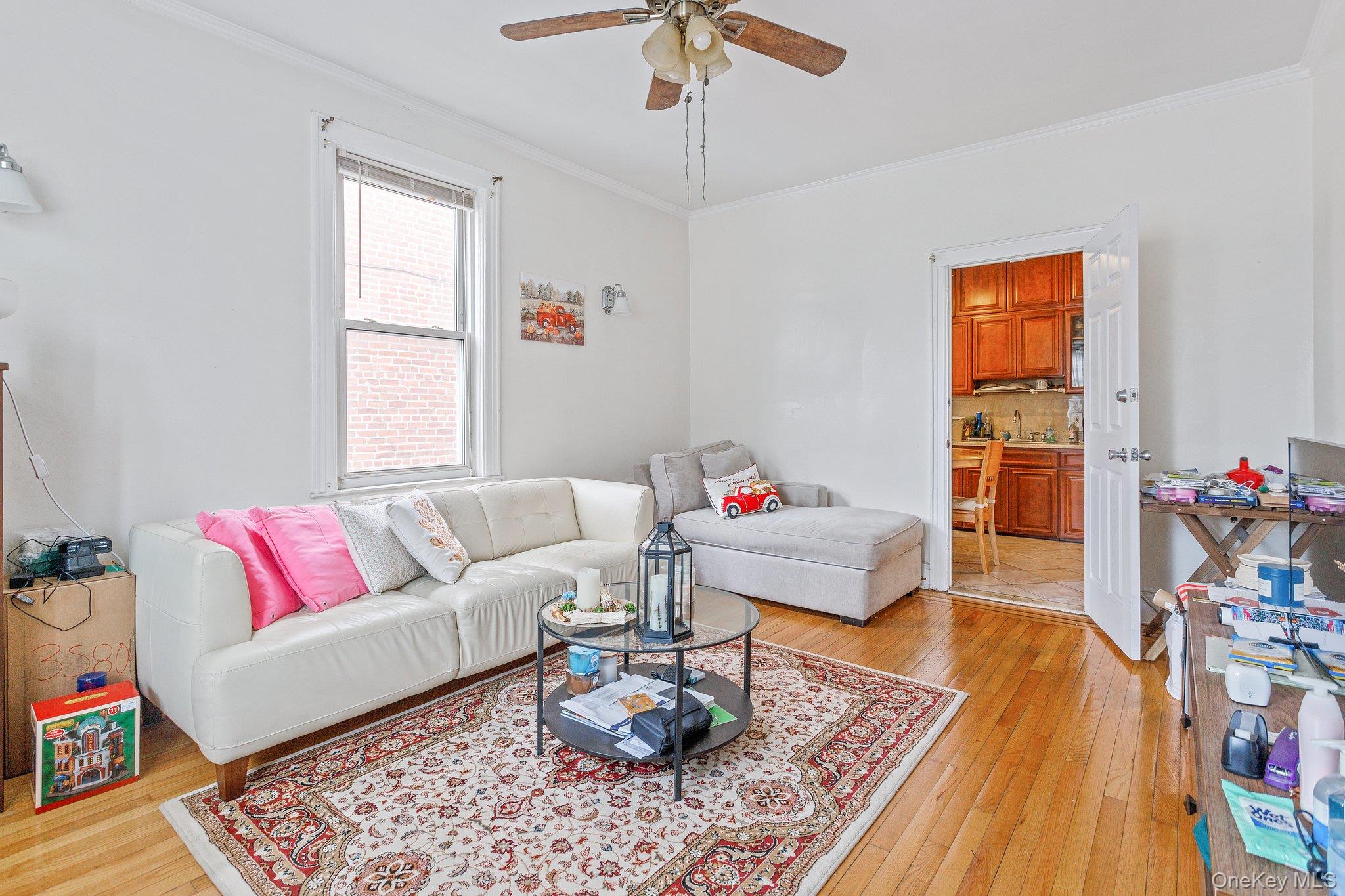 34-29 58th Street Queens, NY 11377 - Photo 12 of 23 a living room with furniture and wooden floor