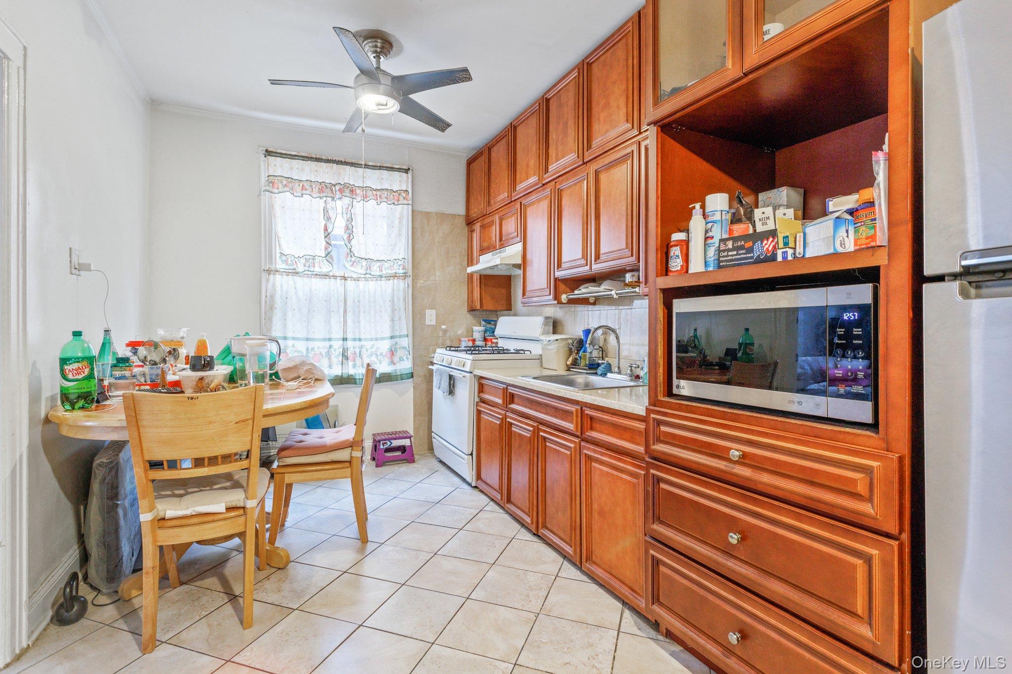34-29 58th Street Queens, NY 11377 - Photo 13 of 23 a kitchen view of a dining table chairs and chandelier
