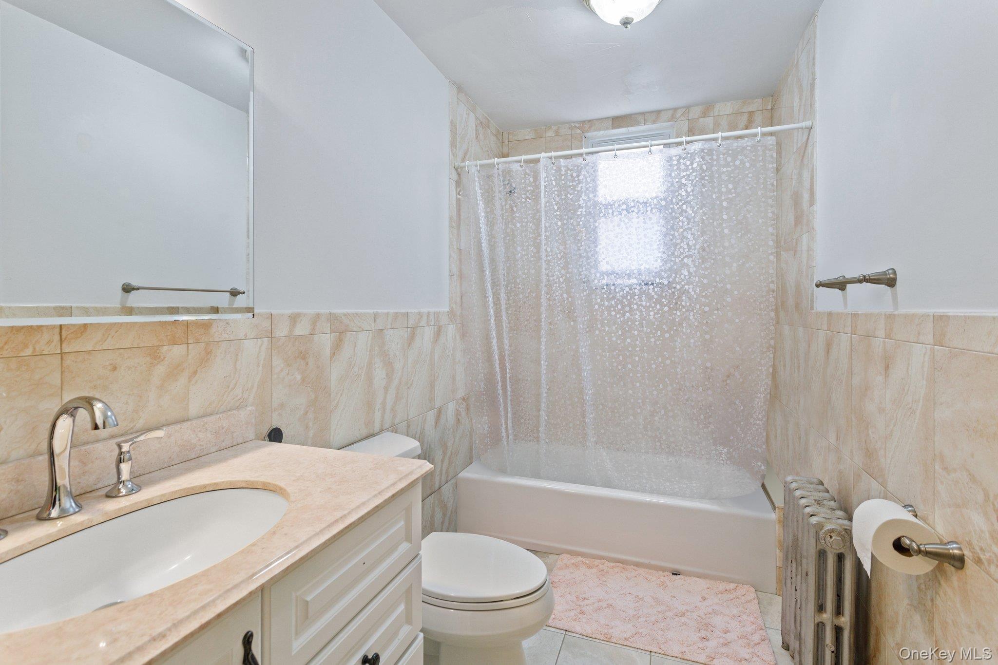 34-29 58th Street Queens, NY 11377 - Photo 18 of 23 a bathroom with a sink toilet and shower