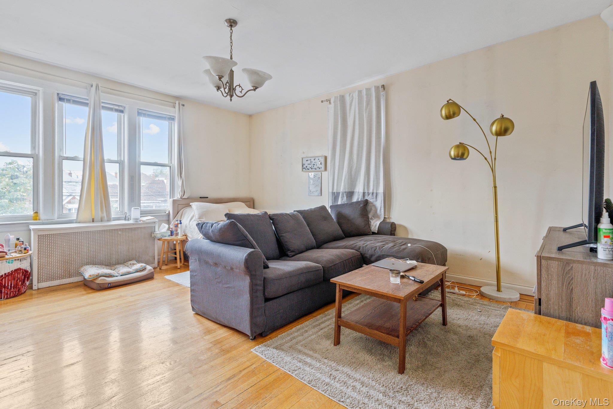 34-29 58th Street Queens, NY 11377 - Photo 2 of 23 a living room with furniture and a window