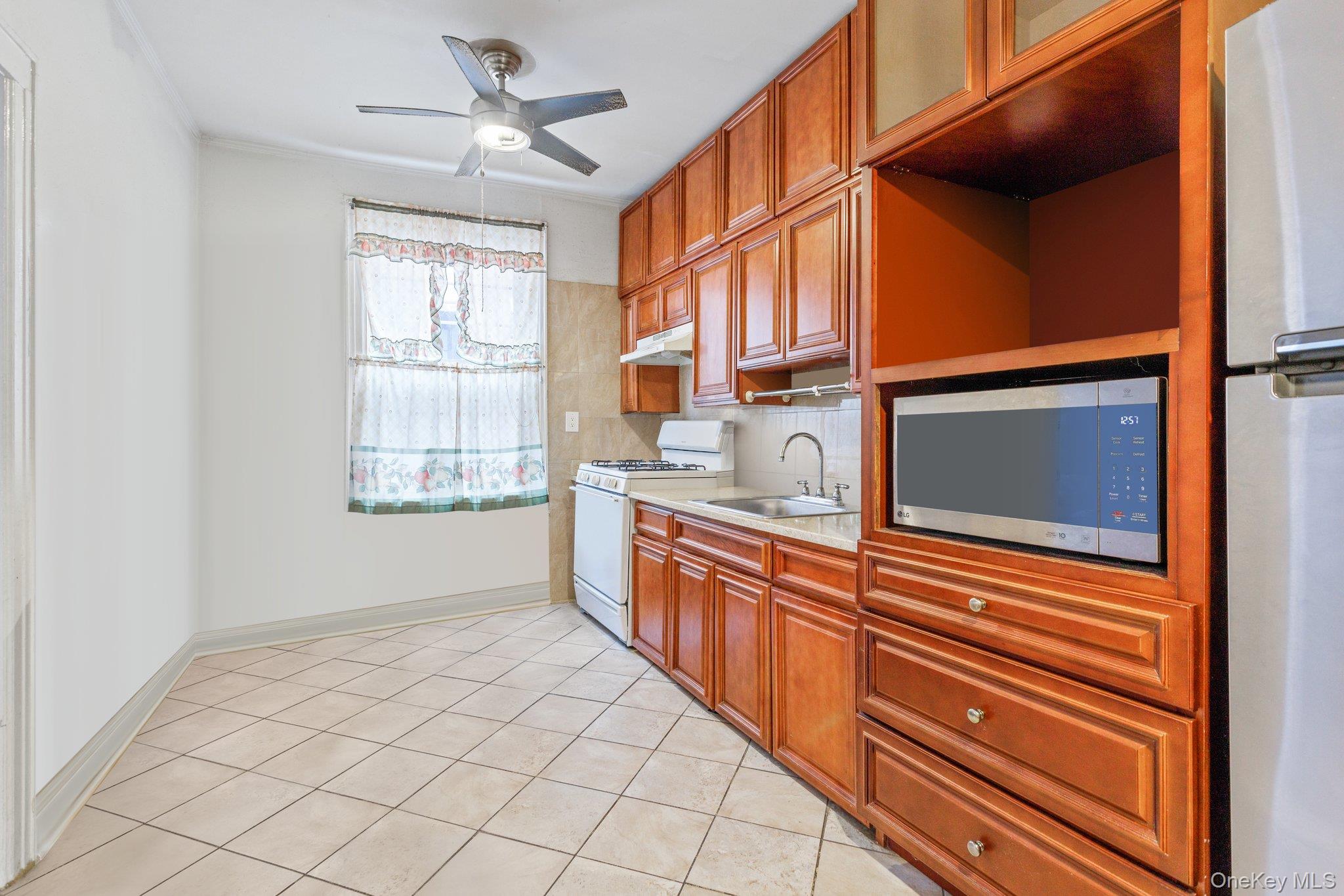 34-29 58th Street Queens, NY 11377 - Photo 23 of 23 a view of a kitchen cabinets a sink and dishwasher
