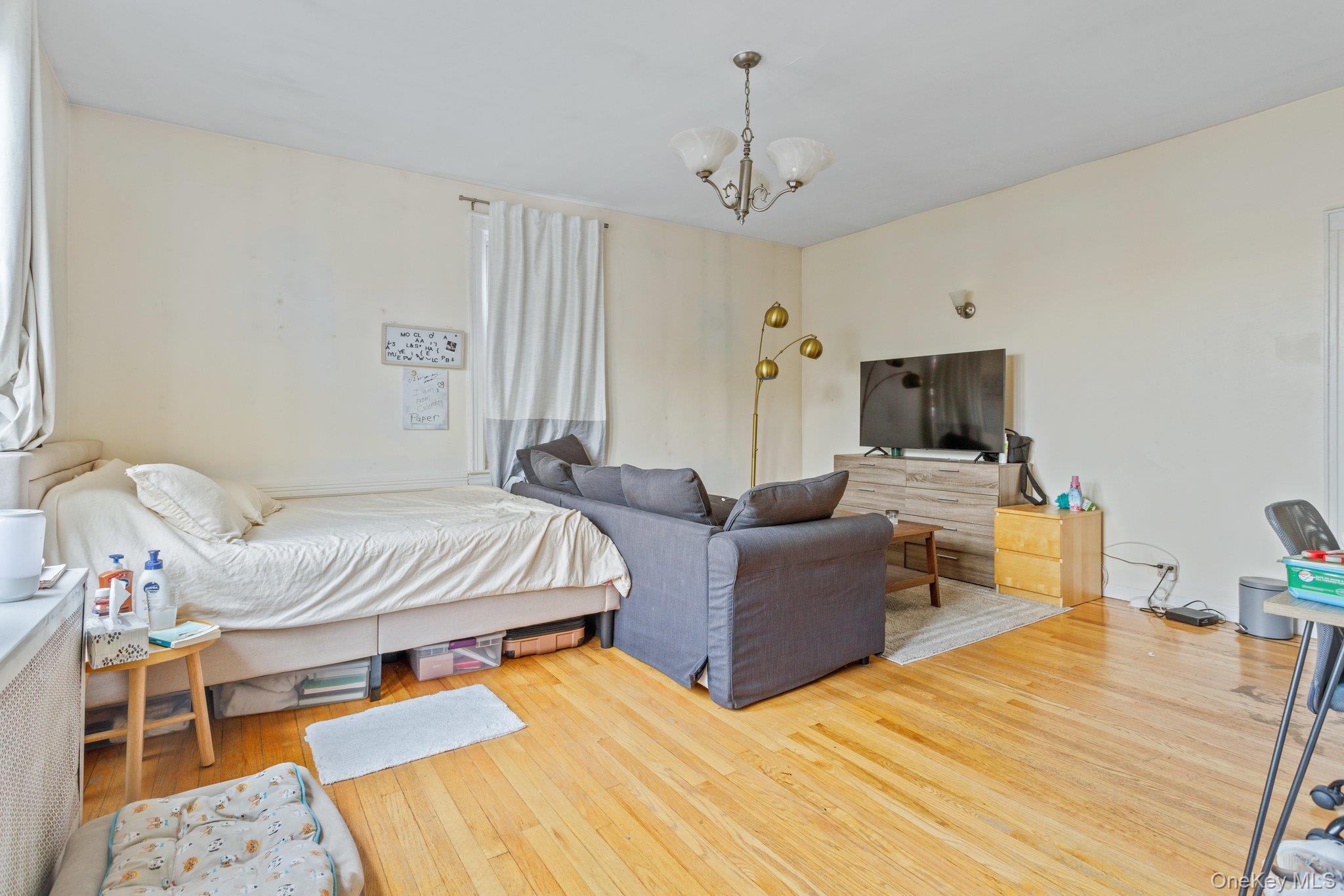 34-29 58th Street Queens, NY 11377 - Photo 3 of 23 a bedroom with a bed and furniture