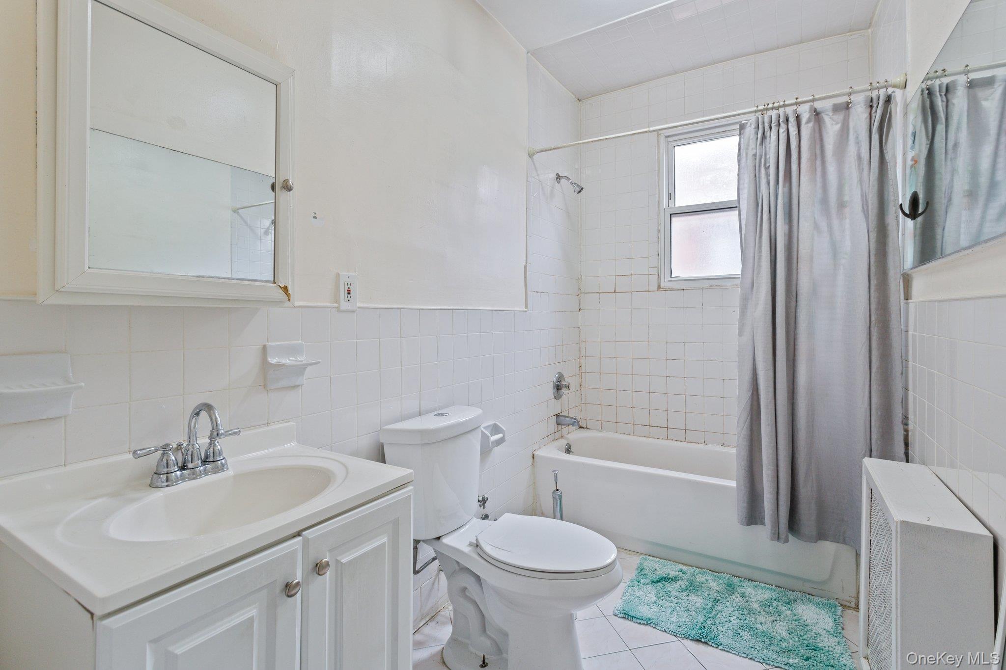 34-29 58th Street Queens, NY 11377 - Photo 4 of 23 a bathroom with a sink toilet a shower and bathtub
