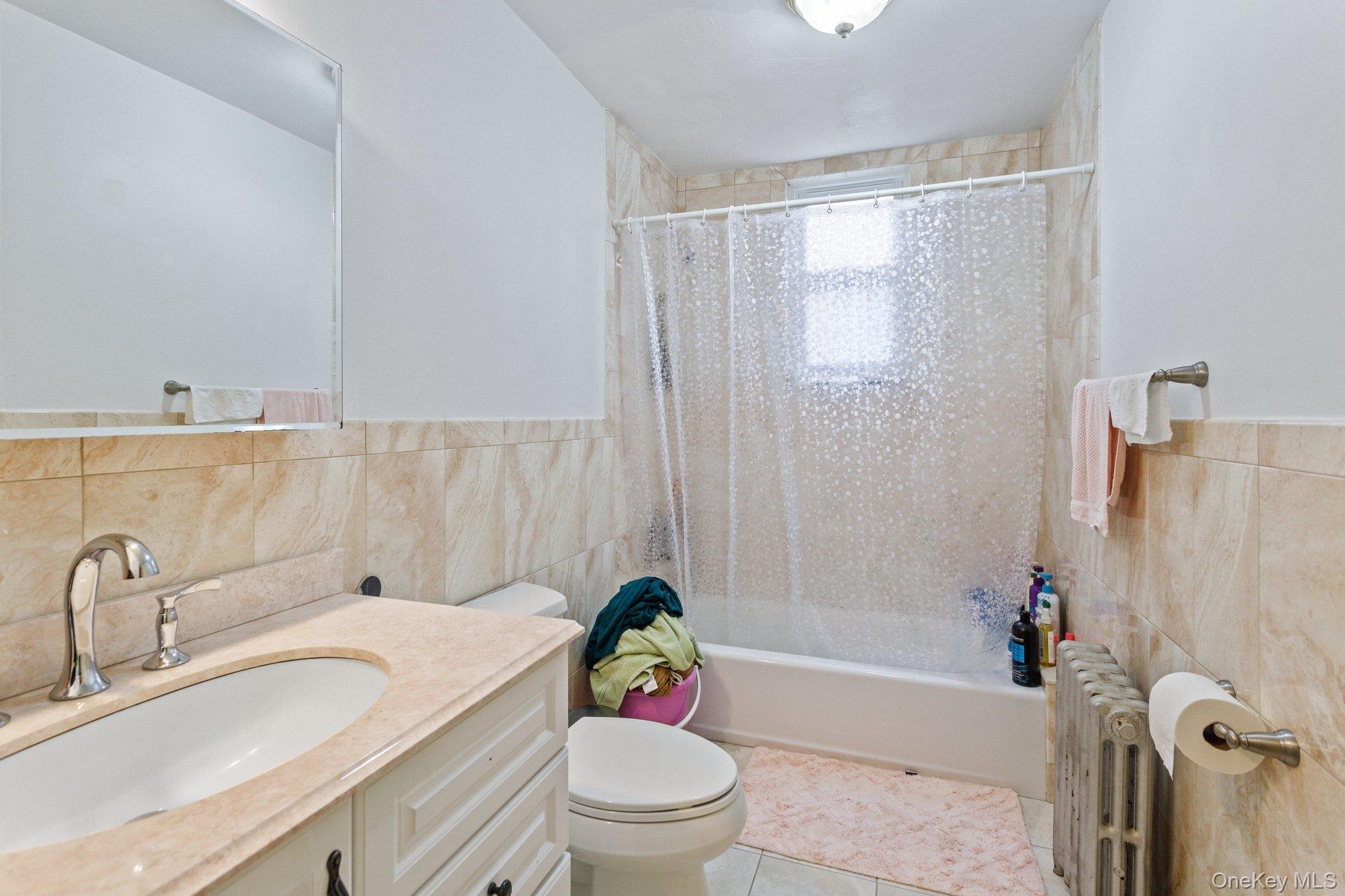 34-29 58th Street Queens, NY 11377 - Photo 8 of 23 a bathroom with a sink toilet and shower